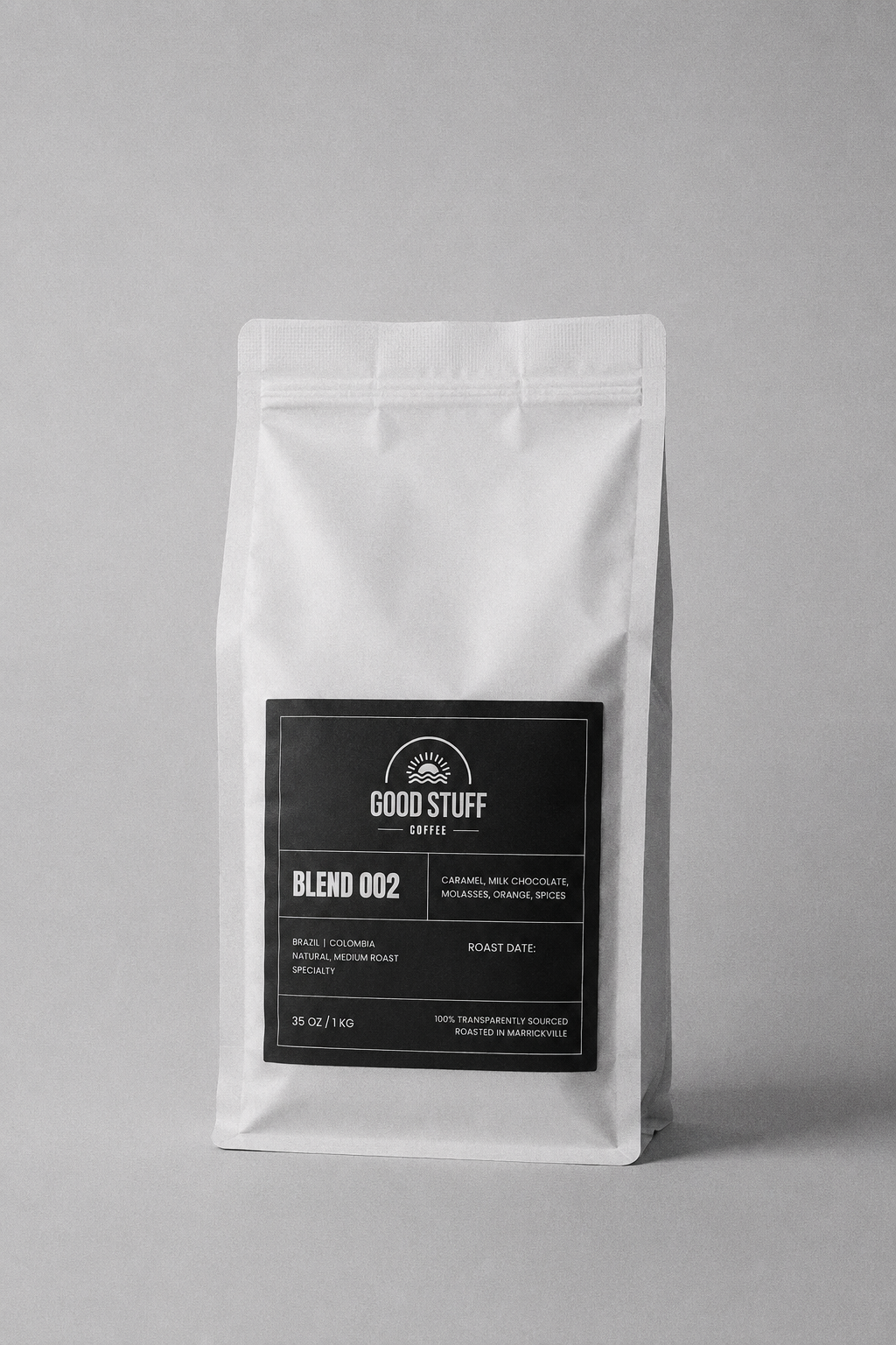 A white stand-up coffee bag with a black front label reading Good Stuff Coffee Blend 002, photographed on a plain light gray background.